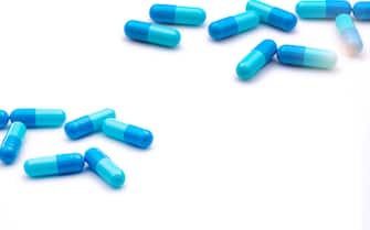 Blue antibiotic capsule pills on white background. Prescription drugs. Antibiotic drug resistance. Antimicrobial capsule pills. Pharmaceutical industry. Healthcare and medicine. Pharmacy product.