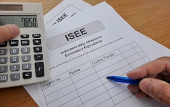 Equivalent Economic Situation Indicator Form Modello ISEE. Man hand writing.