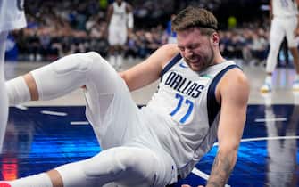 DALLAS, TEXAS - JANUARY 09: Luka Doncic #77 of the Dallas Mavericks holds his knee after going down during play in the first half against the Memphis Grizzlies at American Airlines Center on January 09, 2024 in Dallas, Texas. NOTE TO USER: User expressly acknowledges and agrees that, by downloading and or using this photograph, User is consenting to the terms and conditions of the Getty Images License Agreement. (Photo by Sam Hodde/Getty Images)