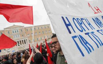 epa10601883 Members of worker unions hold flags outside the parliament building during the May Day celebrations in Athens, Greece, 01 May 2023. International Labor Day also known as May Day is an annual holiday that takes place on 01 May and celebrates workers, their rights, achievements and contributions to society.  EPA/GEORGE VITSARAS