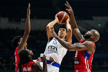 Italy's Simone Fontecchio shoots over Puerto Rico's players during the FIBA Basketball World Cup second round group I game between Italy and Puerto Rico at Smart Araneta Coliseum in Quezon City, metro Manila on September 3, 2023. (Photo by SHERWIN VARDELEON / AFP)