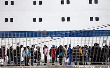LAMPEDUSA, ITALY - APRIL 22:  Migrant men wait to board a ship bound for Sicily on April 22, 2015 in Lampedusa, Italy. Migrants continue to arrive in Lampedusa from North Africa taking advantage of calm seas. Hundreds of migrants are believed to have perished over the last week as they attempted to cross the Mediterranean from Libya to Italy in order to seek refuge.  (Photo by Dan Kitwood/Getty Images)