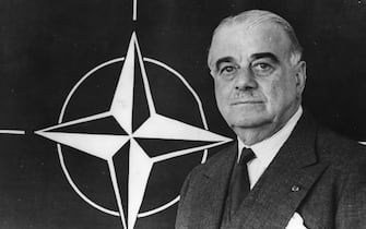 Lord Hastings Lionel Ismay (1887 - 1965) Secretary-General of NATO (1952 - 1957) with the newly adopted NATO emblem behind him.    (Photo by Keystone/Getty Images)