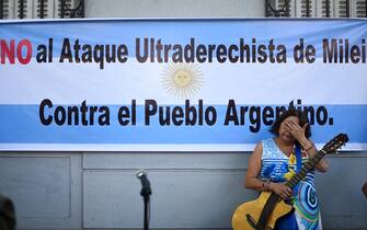 A woman takes part in a demonstration against Argentina's President Javier Milei and in support of the national strike in Santiago, on January 24, 2024. Argentine President Javier Milei faced the first national strike in just 45 days of government, against his draconian fiscal adjustment and his plan to reform more than a thousand laws and regulations that governed for decades. The largest Argentine union called the strike in rejection, in particular, of the changes by decree to the labor regime promoted by Milei, which limit the right to strike and affect the financing of unions. (Photo by Pablo Vera / AFP) (Photo by PABLO VERA/AFP via Getty Images)