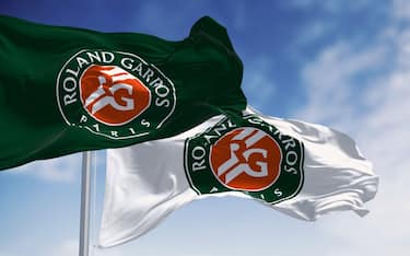 Two flags with the Roland-Garros logo waving in the wind