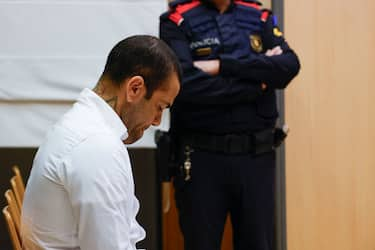 Brazilian footballer Dani Alves reacts at the start of his trial at the High Court of Justice of Catalonia in Barcelona, on February 5, 2024. Brazilian footballer Dani Alves, a former star at Barca and PSG, goes on trial in Barcelona accused of raping a woman in a local nightclub. Prosecutors are asking for a nine-year prison sentence, followed by 10 years of conditional liberty. They are also asking he pay 150,000 euros ($162,000) in compensation to the woman. (Photo by ALBERTO ESTÃ VEZ / POOL / AFP) (Photo by ALBERTO ESTEVEZ/POOL/AFP via Getty Images)