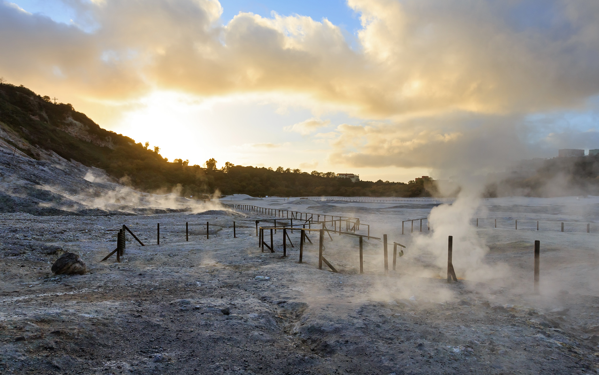 The Solfatara is a shallow volcanic crater with steam with sulfurous fumes ( at Pozzuoli, near Naples).