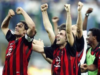 MILAN - MAY 13:  Paolo Maldini of AC Milan celebrates victory with his team mates after the UEFA Champions League semi final second leg match between Inter Milan and AC Milan on May 13, 2003 at the San Siro Stadium in Milan, Italy.  The match ended in a 1-1 draw, AC Milan go through on the away goals rule.  (Photo by Clive Mason/Getty Images)