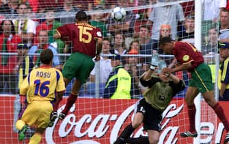 ANH111-20000617-ARNHEM; NETHERLANDS: Portuguese player Costinha (no.15) beats Romanian goalkeeper Bogdan Stelea to score with a header the winning goal for his site during the Euro 2000, Group A soccer championships match Romania vs Portugal at Gelredome stadium in Arnhem, Saturday, 17 June, 2000. Portugal defeated Romania 1-0.       EPA PHOTO/EPA/TOUSSAINT KLUITERS    (ELECTRONIC IMAGE)