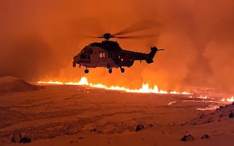 epa11036636 A handout photo made available by the Icelandic Coast Guard shows the crew of TF-EIR, a helicopter of the Coast Guard, that flew over a volcanic eruption to estimate its scale after an eruption began, north of Grindavik, on the Reykjanes peninsula, in Iceland, late 18 December 2023, (issued 19 December 2023). An evacuation order for the population of Grindavik was issued early this year on 10 November 2023 following seismic activity and indications of considerable magma movement in the area.  EPA/ICELANDIC COAST GUARD / HANDOUT BEST QUALITY AVAILABLE HANDOUT EDITORIAL USE ONLY/NO SALES HANDOUT EDITORIAL USE ONLY/NO SALES