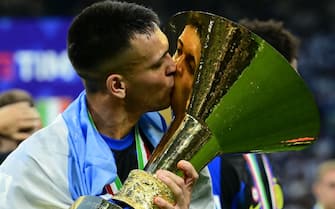 Inter Milan's Argentine forward #10 Lautaro Martinez kisses the trophy  during the ceremony for the Italian Champions following the Italian Serie A football match between Inter Milan and Lazio in Milan, on May 19, 2024. Inter celebrates his 20th Scudetto. (Photo by Marco BERTORELLO / AFP) (Photo by MARCO BERTORELLO/AFP via Getty Images)