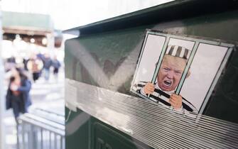 Trump epa10556345 A sticker with the face of former President Donald J. Trump is displayed in front of New York Criminal Court in New York, New York, USA, 02 April 2023. A Manhattan grand jury voted to indict former President Donald J. Trump last week and he is reportedly planning to turn himself in at the courthouse and appear before a judge to hear the charges against him on 04 April. EPA/JUSTIN LANE