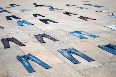 PIAZZA CASTELLO, TURIN, ITALY - 2021/04/28: Pairs of jeans are seen during a flash mob for the Denim Day and against gender violence organized by 'Break the Silence'. Denim Day takes place on the last Wednesday of April, it was born following a 1998 Italian Court of Cassation ruling overturning a rape conviction because the victim was wearing tight jeans. (Photo by NicolÃ² Campo/LightRocket via Getty Images)