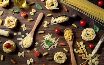 Various pasta on wooden background