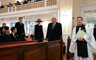 US President-elect Donald Trump, trailed by Melania Trump and son Barron Trump, arrives for a church service at St. John's Episcopal Church, Lafayette Square in Washington, DC, January 20, 2025. (Photo by Jim WATSON / AFP)