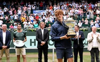 Italy's Jannik Sinner (3rd R) holds his trophy after defeating Poland's Hubert Hurkacz (2nd L) in the men's singles final tennis match of the ATP 500 Halle Open tennis tournament in Halle, western Germany on June 23, 2024. (Photo by CARMEN JASPERSEN / AFP)