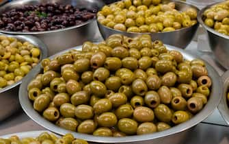 Bowls with different types of olives on the market