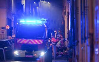 Rescue personnel work near the scene where a building collapsed in the southern French port city of Marseille  early on April 9, 2023. - A building in the southern French port city of Marseille collapsed, police told AFP early on April 9, though it was unclear whether there were any victims. (Photo by NICOLAS TUCAT / AFP) (Photo by NICOLAS TUCAT/AFP via Getty Images)