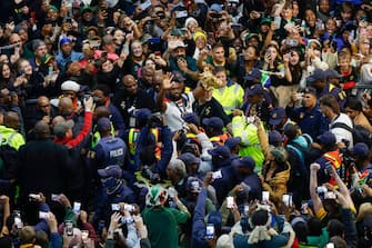 South Africa's flanker and captain Siya Kolisi (C) holds the Webb Ellis Cup as he leaves after the South African rugby team's arrival at the OR Tambo International airport in Ekurhuleni on October 31, 2023, after they won the France 2023 Rugby World Cup final match against New Zealand. (Photo by PHILL MAGAKOE / AFP) (Photo by PHILL MAGAKOE/AFP via Getty Images)