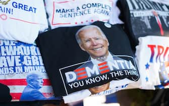 MILWAUKEE, WISCONSIN, UNITED STATES - 2024/07/16: A vendor sells t-shirts of a photo of president Joe Biden with the word, “Dementia,” outside Finserv Forum on the second day of the Republican National Convention (RNC). The Republican National Convention (RNC) is going on as planned despite the assassination attempt against Trump will conclude with him accepting his party's presidential nomination. (Photo by Jeremy Hogan/SOPA Images/LightRocket via Getty Images)