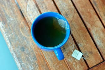 Blue Tea Cup on Wooden Garden Table