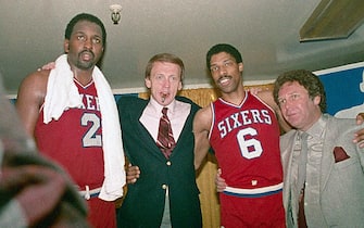 (Original Caption) Philadelphia 76ers' Moses Malone (2) and Julius Erving (6) hug their coach Bill Cunninham in the dressing room after the 76ers made a clear 4 game sweep over the Los Angeles Lakers to win the NBA Championship at the Forum 5/31, 115-108.