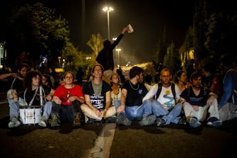 Demonstrators sit on the main road and block it at a demonstration for the kidnapping deal near the Knesset, on March 31, 2024, in Jerusalemm Israel. (Photo by Yahel Gazit / Middle East Images / Middle East Images via AFP) (Photo by YAHEL GAZIT/Middle East Images/AFP via Getty Images)