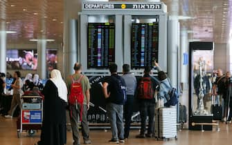 Passengers check their flight status in the departure terminal in Ben Gurion airport on the morning after a drone and missile attack from Iran, near Tel Aviv, Israel on Sunday, April 14, 2024. Israel and allies including the US, UK and France managed to mostly foil an unprecedented attack by Iran on the Jewish state. Photographer: Kobi Wolf/Bloomberg