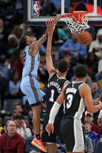 MEMPHIS, TENNESSEE - JANUARY 02: Ja Morant #12 of the Memphis Grizzlies goes to the basket against Victor Wembanyama #1 of the San Antonio Spurs during the second half at FedExForum on January 02, 2024 in Memphis, Tennessee. NOTE TO USER: User expressly acknowledges and agrees that, by downloading and or using this photograph, User is consenting to the terms and conditions of the Getty Images License Agreement. (Photo by Justin Ford/Getty Images)