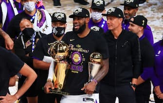 LAKE BUENA VISTA, FLORIDA - OCTOBER 11: LeBron James #23 of the Los Angeles Lakers reacts with his MVP trophy and Finals trophy after winning the 2020 NBA Championship over the Miami Heat in Game Six of the 2020 NBA Finals at AdventHealth Arena at the ESPN Wide World Of Sports Complex on October 11, 2020 in Lake Buena Vista, Florida. NOTE TO USER: User expressly acknowledges and agrees that, by downloading and or using this photograph, User is consenting to the terms and conditions of the Getty Images License Agreement.  (Photo by Mike Ehrmann/Getty Images)