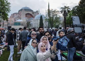 epa10583399 Muslims take a selfie before taking part in Eid al-Fitr prayers in front of the Hagia Sophia Grand Mosque in Istanbul, Turkey, 21 April 2023. Muslims around the world celebrate Eid al-Fitr, the three-day festival marking the end of Ramadan that is one of the two major holidays in the Islamic calendar.  EPA/ERDEM SAHIN