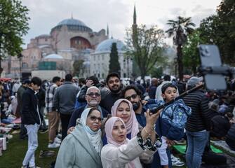 epa10583399 Muslims take a selfie before taking part in Eid al-Fitr prayers in front of the Hagia Sophia Grand Mosque in Istanbul, Turkey, 21 April 2023. Muslims around the world celebrate Eid al-Fitr, the three-day festival marking the end of Ramadan that is one of the two major holidays in the Islamic calendar.  EPA/ERDEM SAHIN