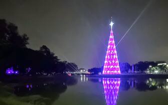 People are admiring the Ibirapuera Christmas tree in Sao Paulo, Brazil, on December 17, 2023. Standing at 57 meters tall, the symbol is located in Ibirapuera Park in the southern part of the city, and its theme is ''A Christmas Night's Dream.'' (Photo by Cris Faga/NurPhoto via Getty Images)