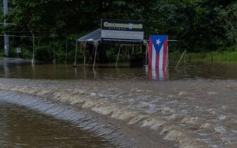 Flooding caused by Tropical Storm Ernesto blocked a major road in Toa Baja, Puerto Rico on Aug. 14, 2024. President Biden approved an emergency declaration for Puerto Rico late Tuesday night. More than 700,000 customers lost power as a result of the storm.