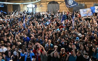 Fans of SSC Napoli gathered in the San Lorenzo district on May 4, 2023 in Naples to watch a live broadcast of a potentially decisive match between Udinese and Napoli played in Udine, react after Napoli scored an equalizer, anticipating the celebration of the club's Italian champions "Scudetto" title, as Napoli is to play a potentially decisive match in Udine. - Napoli has been waiting 33 years to be named Italian champions, and a potentially decisive game on May 4 against Udinese in Udine may secure the title. (Photo by Filippo MONTEFORTE / AFP) (Photo by FILIPPO MONTEFORTE/AFP via Getty Images)