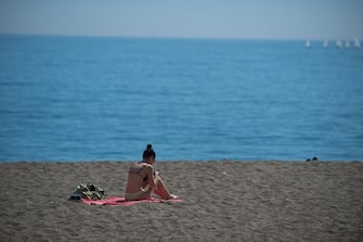 MALAGA, SPAIN - 2023/03/12: A bather is seen resting at La Malagueta beach during a hot spring day. The good weather and high temperatures have made the beaches along the Andalusian coast full. The Spanish state meteorology agency warned of an unusual episode of high temperatures over the next few days, with temperatures that could reach over 30 degrees. (Photo by Jesus Merida/SOPA Images/LightRocket via Getty Images)