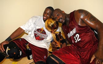 DALLAS - JUNE 20:  Dwyane Wade #3 and Shaquille O'Neal #32 of the Miami Heat celebrate with the Larry O'Brien Championship trophy after their Game Six victory of the 2006 NBA Finals against the Dallas Mavericks on June 20, 2006 at American Airlines Center in Dallas, Texas. The Heat defeated the Mavericks 95-92 to win their first NBA Championship.  NOTE TO USER: User expressly acknowledges and agrees that, by downloading and or using this photograph, User is consenting to the terms and conditions of the Getty Images License Agreement. Mandatory Copyright Notice: Copyright 2006 NBAE  (Photo by Andrew D. Bernstein/NBAE via Getty Images)