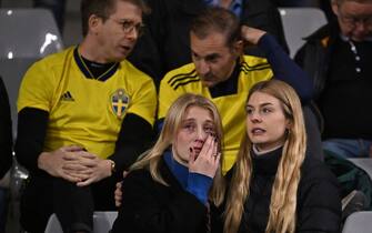 Swedish supporters react as they wait in the stand during the Euro 2024 qualifying football match between Belgium and Sweden at the King Baudouin Stadium in Brussels on October 16, 2023, after an 'attack' that targeted Swedish citizens in a street of Brussels. Belgian federal prosecutor leading on terrorism cases launched an investigation into an attack that left two dead in Brussels on October 16, 2023 evening, a spokesman told AFP. Belgium PM slams Brussels 'attack' targeting Swedish citizens. (Photo by JOHN THYS / AFP) (Photo by JOHN THYS/AFP via Getty Images)