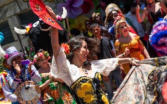 epa11140134 A woman wearing a costumes dances during the handing over of the keys to the city to King Momo Caio Cesar Dutra and Carnival Queen Gabriella Mendes (both not pictured) in Rio de Janeiro, Brazil, 09 February 2024. The event marks the official start of the Carnival 2024 festivities in Rio de Janeiro.  EPA/Andre Coelho