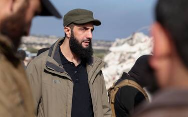 Hayat Tahrir al-Sham (HTS) jihadist group's chief Abu Mohamed al-Jolani (L) checks the damage following an earthquake in the village of Besnaya in Syria's rebel-held northwestern Idlib province at the border with Turkey, on February 7, 2023. (Photo by Omar HAJ KADOUR / AFP) (Photo by OMAR HAJ KADOUR/AFP via Getty Images)