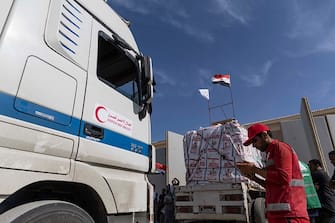 NORTH SINAI, EGYPT - OCTOBER 21: Aid convoy trucks are checked as they prepare to cross the Rafah border from the Egyptian side on October 21, 2023 in North Sinai, Egypt.  The aid convoy, organized by a group of Egyptian NGOs, set off Saturday 14th October from Cairo for the Gaza-Egypt border crossing at Rafah. A week of tortuous negotiations followed about when the border, controlled by Egypt on one side and Hamas on the other, would be opened, until the first trucks were admitted on 21st October.  On October 7th, the Palestinian militant group Hamas launched a surprise attack on border communities in southern Israel, spurring the most violent flare-up of the Israel-Palestine conflict in decades. Israel launched a vast bombing campaign in retaliation and has warned of an imminent ground invasion.(Photo by Mahmoud Khaled/Getty Images)