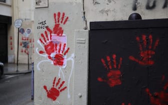A picture shows red hand graffitis painted on a wall of the Sainte-Croix de la Bretonnerie street, in the area where earlier the Holocaust memorial was vandalized with the same red hand prints in Paris, on May 14, 2024. A French Jewish organisation on May 14 condemned a "hateful rallying cry against Jews" and Paris authorities filed a criminal complaint after red hand graffiti was painted onto France's Holocaust Memorial. (Photo by Antonin UTZ / AFP) (Photo by ANTONIN UTZ/AFP via Getty Images)