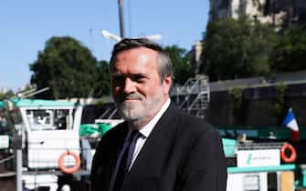epa10739069 CEO of French waterways Thierry Guimbaud poses for the camera in front of Notre Dame Cathedral after the installation of the first framework in Paris, France, 11 July 2023. The oak trusses of the framework are 14 to 16 metres wide and 12 to 13 metres high and weigh between 7 and 7.5 tons, and are the main framework for the Cathedral's spire. Since the fire which devastated the cathedral on 15 April 2019, hundreds of people are working on its reconstruction with the target to reopen the Cathedral before the end of 2024.  EPA/TERESA SUAREZ