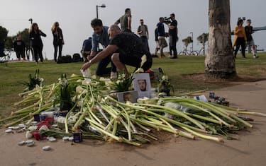 People gather to pay condolences and lay flowers at the site where Alessandro Parini, an Italian tourist, was killed Friday night in a terrorist attack, in Tel Aviv, Israel, Saturday, April 8, 2023. (Photo by Bea Bar Kallosh/NurPhoto via Getty Images)