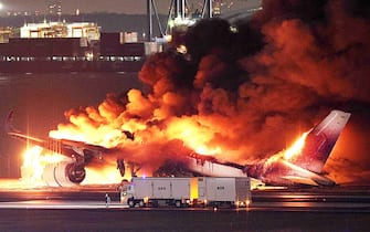 This photo provided by Jiji Press shows a Japan Airlines plane on fire on a runway of Tokyo's Haneda Airport on January 2, 2024. A Japan Airlines plane was in flames on the runway of Tokyo's Haneda Airport on January 2 after apparently colliding with a coast guard aircraft, media reports said. (Photo by JIJI PRESS / AFP) / Japan OUT (Photo by STR/JIJI PRESS/AFP via Getty Images)