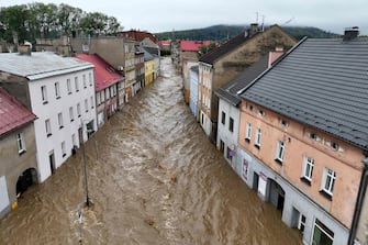 TOPSHOT - This aerial photograph taken on September 15, 2024 shows a view of the flooded streets in Glucholazy, southern Poland. One person has drowned in Poland and an Austrian fireman has died responding to floods, authorities said, as Storm Boris lashed central and eastern Europe with torrential rains. Since Thursday, September 12, 2024, swathes of Austria, the Czech Republic, Hungary, Romania and Slovakia have been hit by high winds and unusually fierce rainfall. The storm had already caused the death of five people in Romania, and thousands have been evacuated from their homes across the continent. (Photo by Sergei GAPON / AFP)