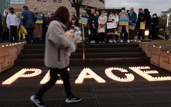 OSAKA, JAPAN - FEBRUARY 24: Ukrainians living in Japan hold anti-war placards and take part in the candlelight vigil for peace at the Osaka Museum of History site on February 24, 2023 in Osaka, Japan. Ukrainians living in Japan are marking the anniversary of the start of the war in Ukraine. (Photo by Buddhika Weerasinghe/Getty Images