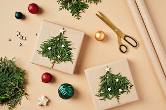 Eco-Conscious Christmas decorations with gift boxes on beige background.