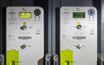Two Fluvius Siconia T211 3-phase smart meters in flat, electronic devices that records consumption of electricity / electric energy information