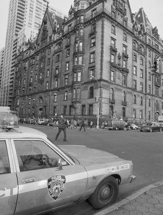 (Original Caption) Police direct traffic outside the Dakota, an apartment house, December 9th, the morning after former Beatle John Lennon was shot to death in front of the building. Police say Lennon was shot by a deranged man who had been stalking him for days.